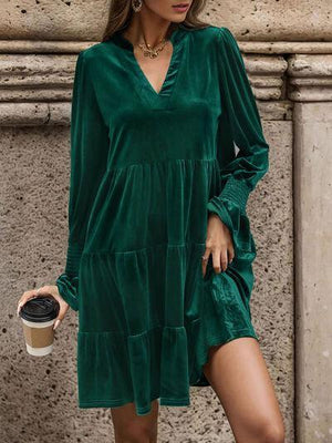 a woman in a green dress holding a cup of coffee