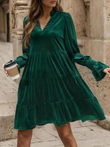 a woman in a green dress holding a cup of coffee