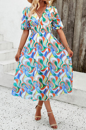 a woman wearing a colorful dress and hat