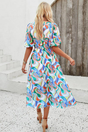 a woman in a colorful dress walking down the street