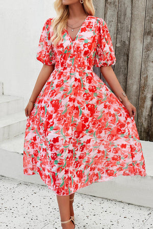 a woman in a red floral print dress