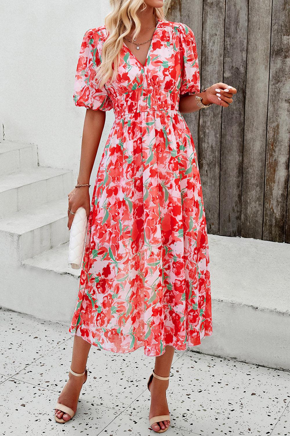 a woman in a red floral print dress