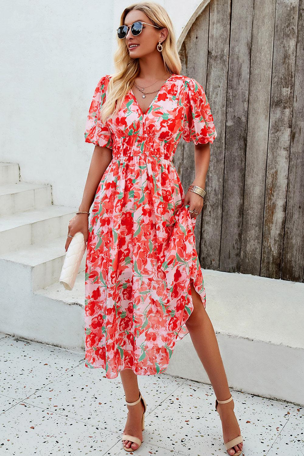 a woman in a red floral print dress