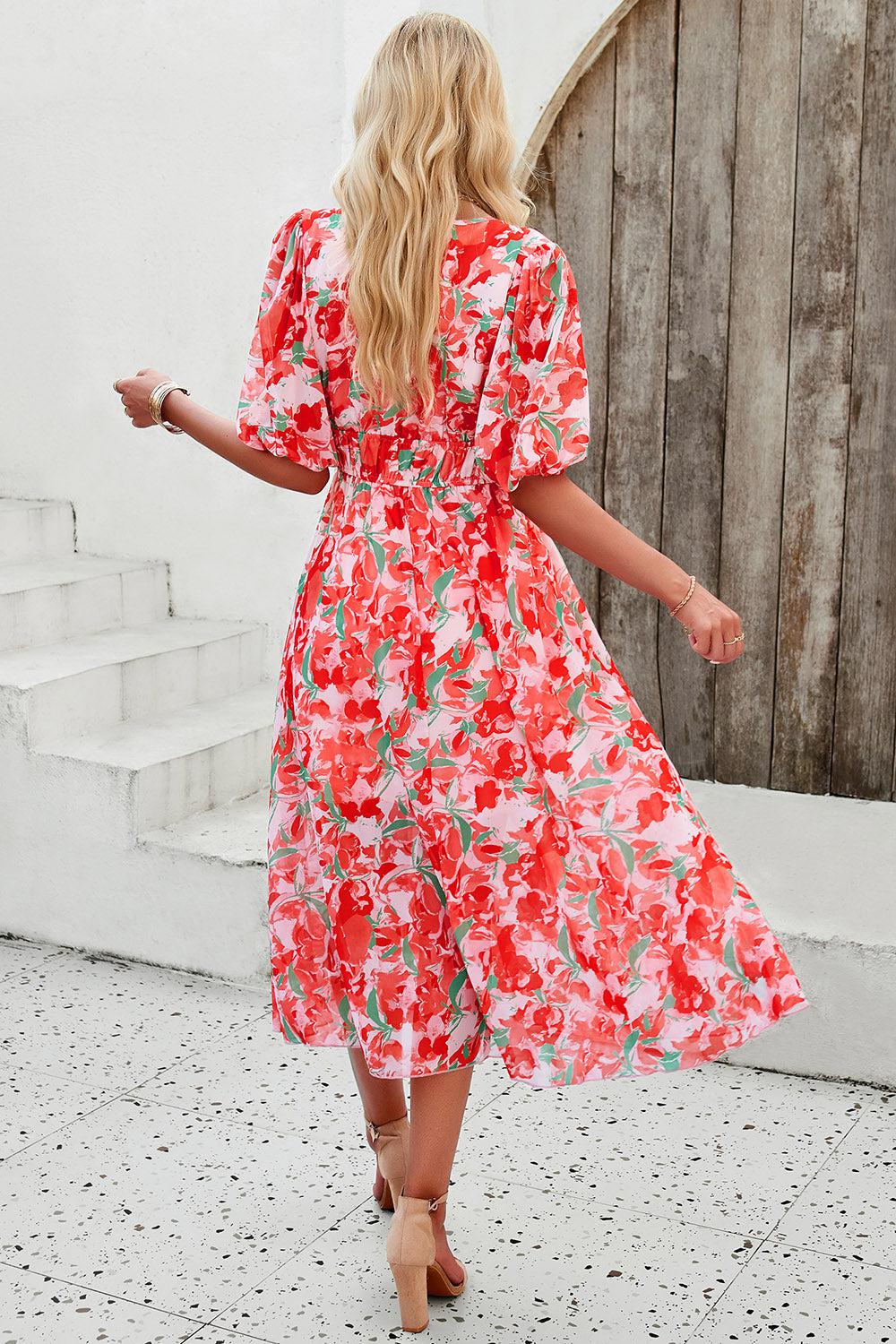 a woman in a red floral print dress