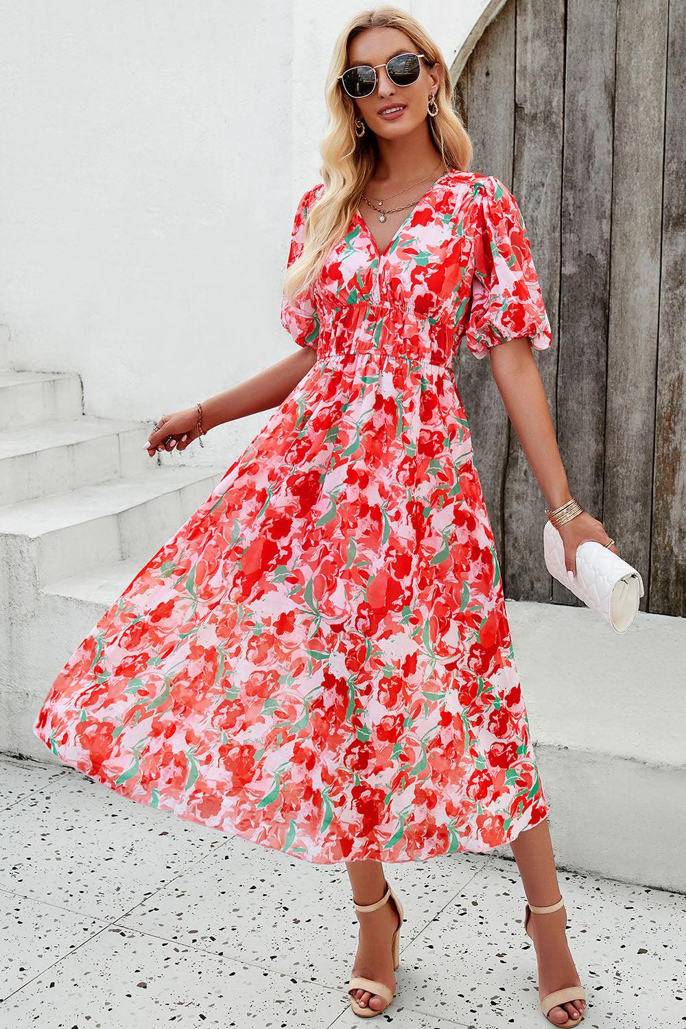 a woman in a red floral print dress