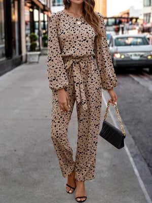 a woman wearing a leopard print jumpsuit and heels