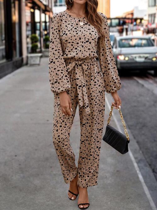 a woman wearing a leopard print jumpsuit and heels