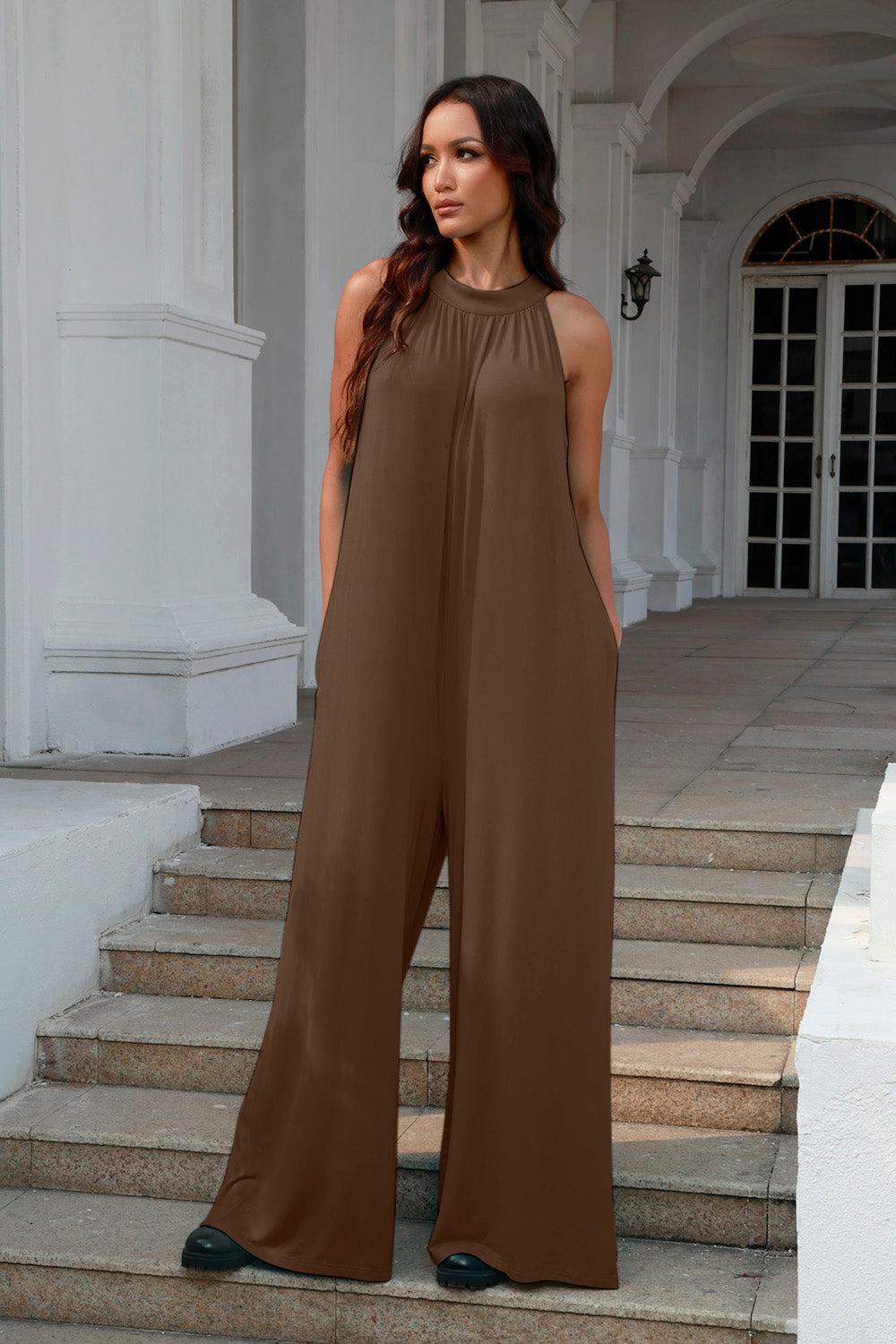 a woman standing on a set of steps wearing a brown jumpsuit