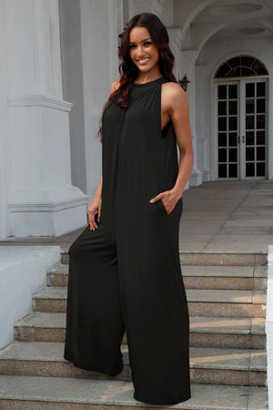 a woman in a black jumpsuit standing on some steps