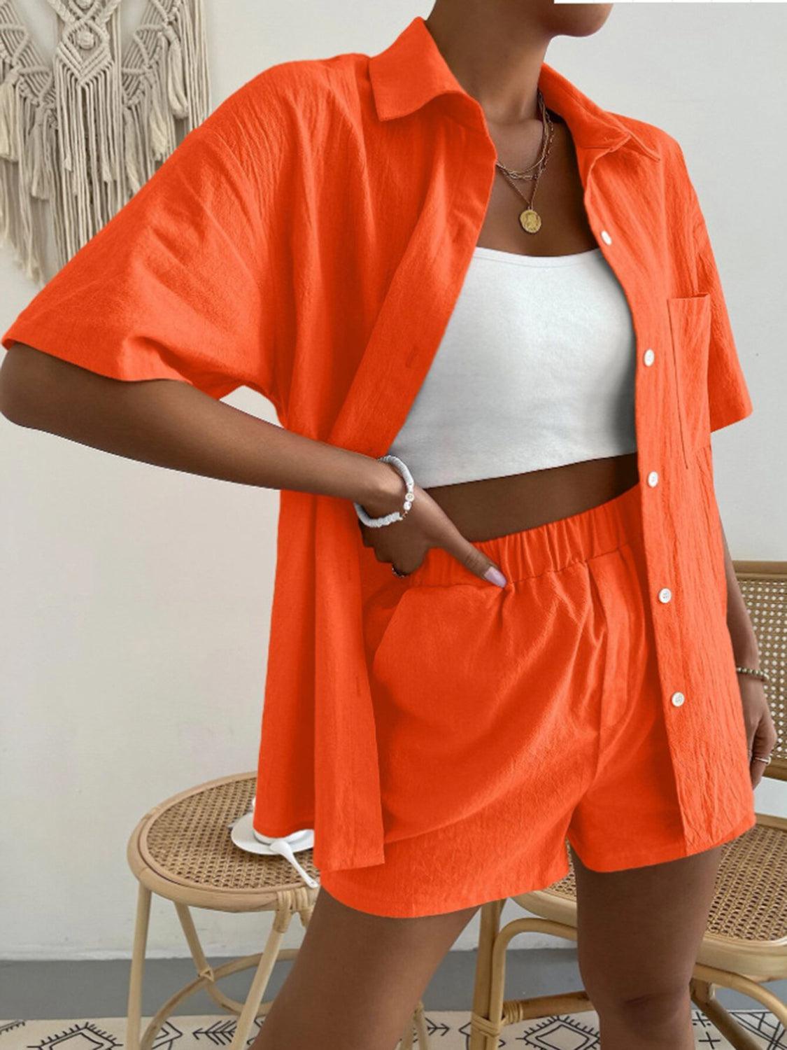 a woman wearing an orange jacket and shorts