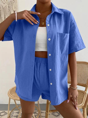 a woman wearing a blue shirt and shorts