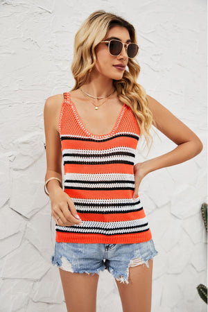 a woman wearing an orange and black striped tank top