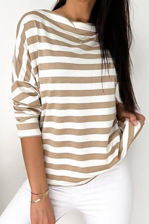 a woman wearing a brown and white striped sweater