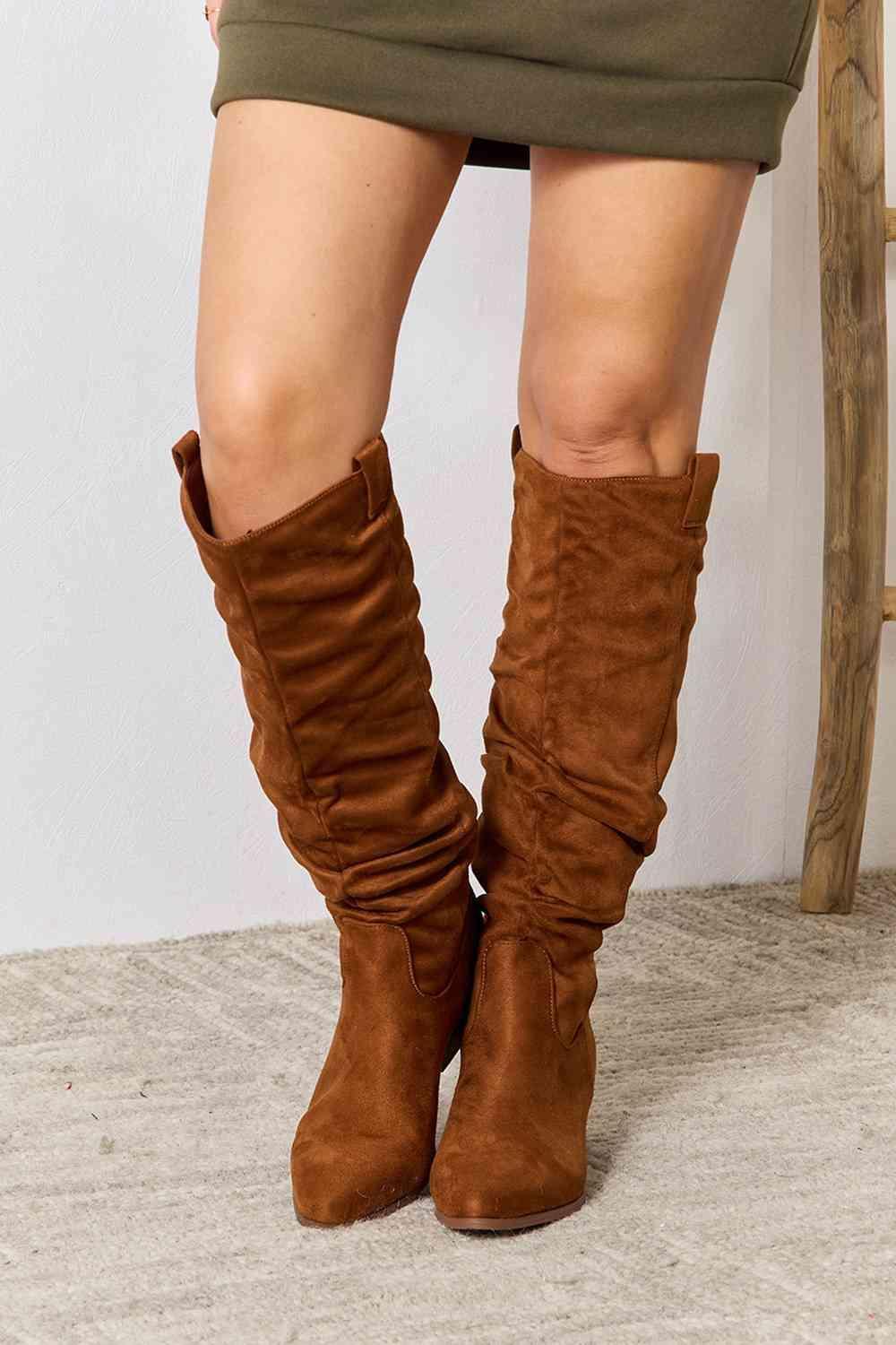 a close up of a person wearing brown boots