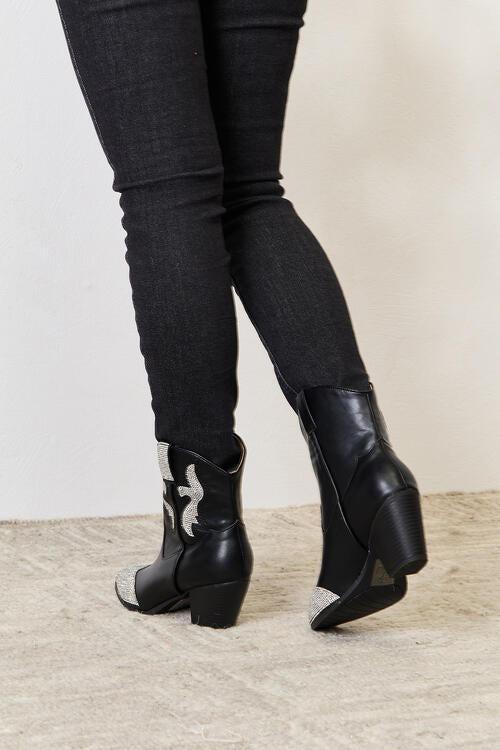 a close up of a person wearing black boots