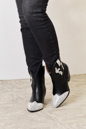 a close up of a person wearing black and white shoes