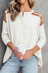 a woman wearing a white sweater and jeans