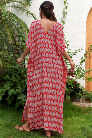 a woman in a red and white printed dress