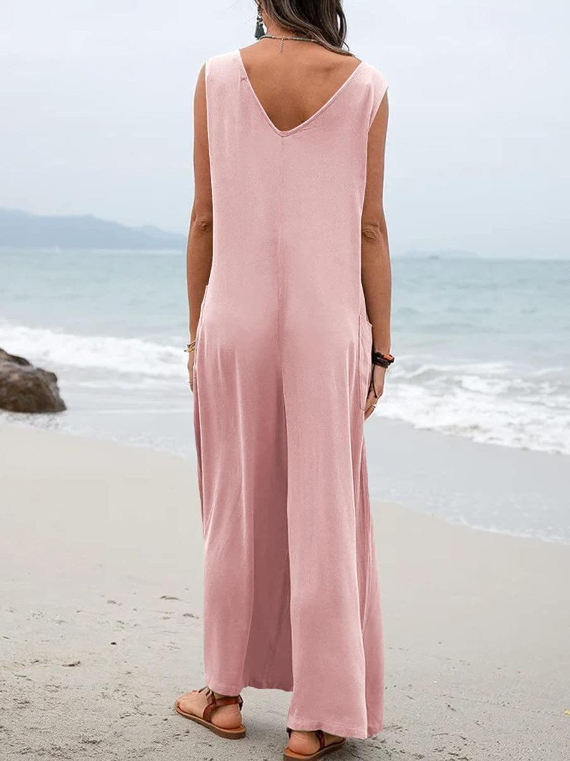 a woman standing on a beach looking at the ocean