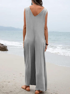 a woman standing on a beach looking out at the ocean