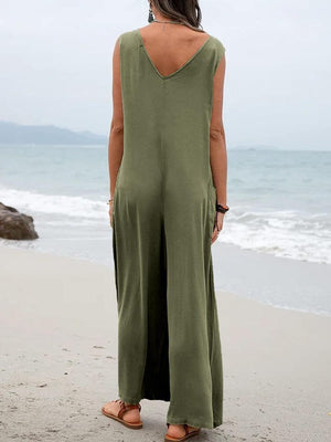 a woman standing on a beach looking at the ocean