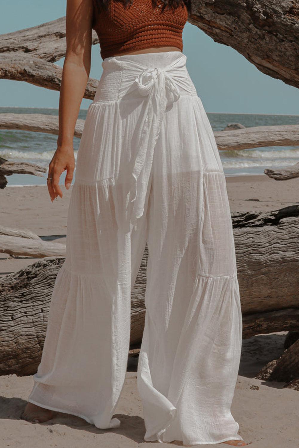 a woman standing on top of a sandy beach