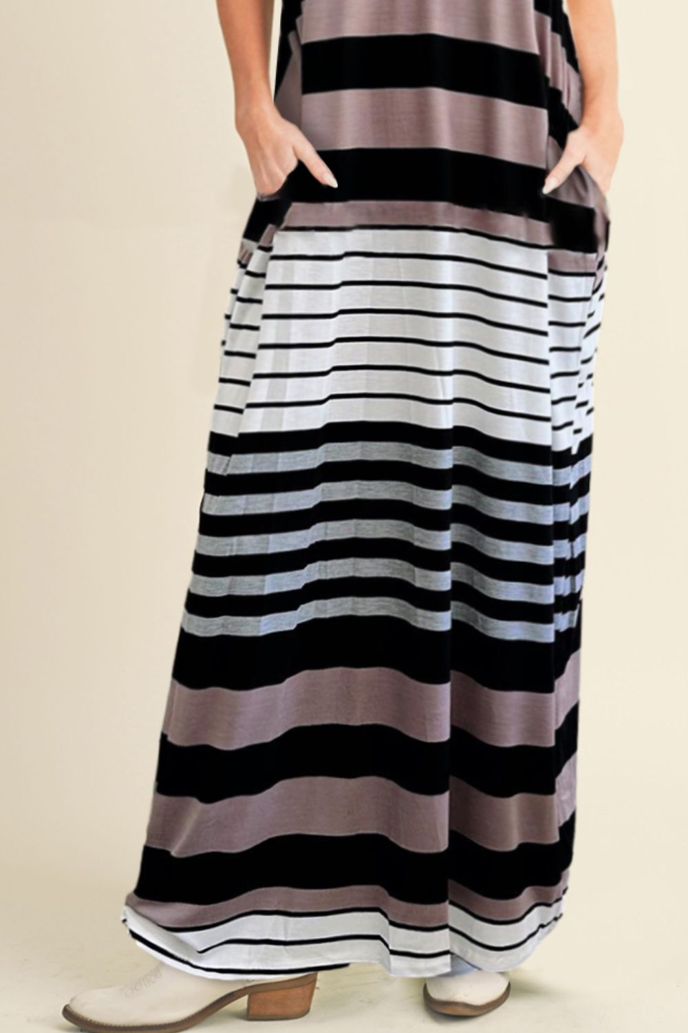 a woman wearing a black and white striped dress