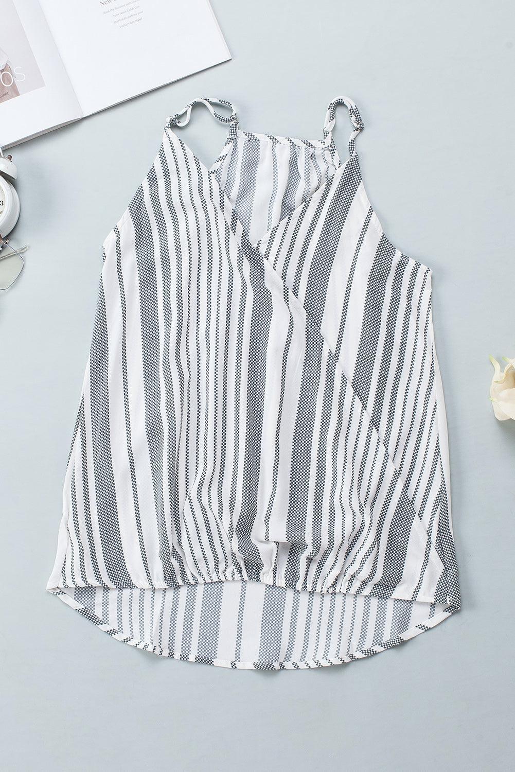 a white and black striped top next to a book