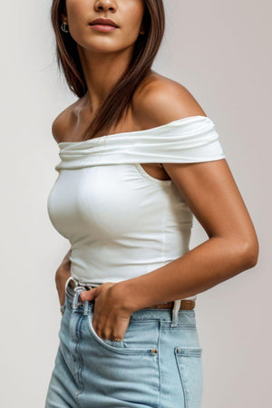 a woman in a white top posing for a picture