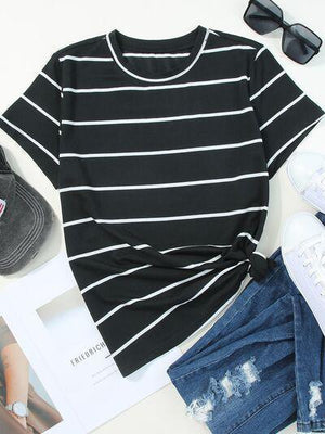 a women's black and white striped shirt and ripped jeans