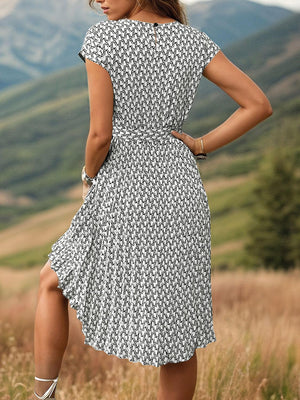 a woman in a dress standing in a field