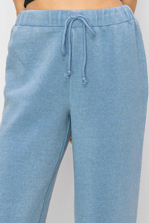 a close up of a person wearing blue sweat pants