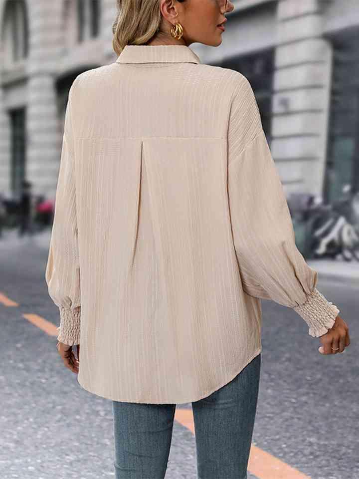 a woman walking down the street wearing a white shirt and jeans