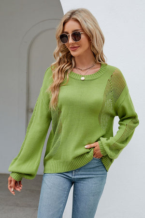 a woman wearing a green sweater and jeans