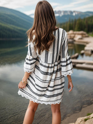 a woman standing on the shore of a lake