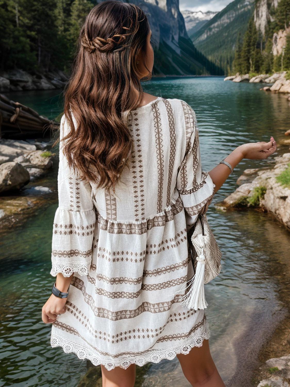 a woman in a white dress standing by a river