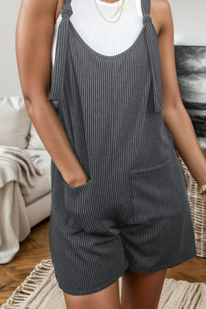 a woman wearing a black and white striped romper