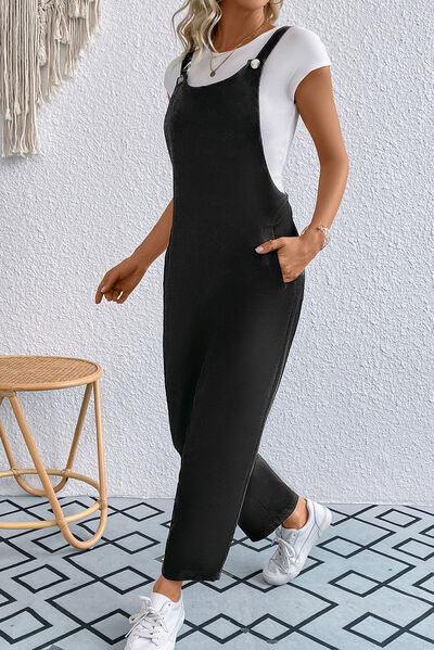 a woman wearing a black and white jumpsuit