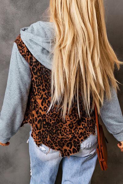 a woman with long blonde hair wearing a leopard print vest