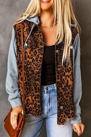 a woman wearing a leopard print jacket and jeans