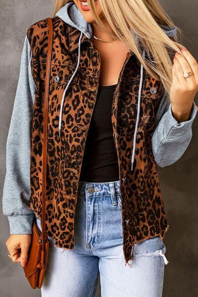 a woman wearing a leopard print jacket and jeans