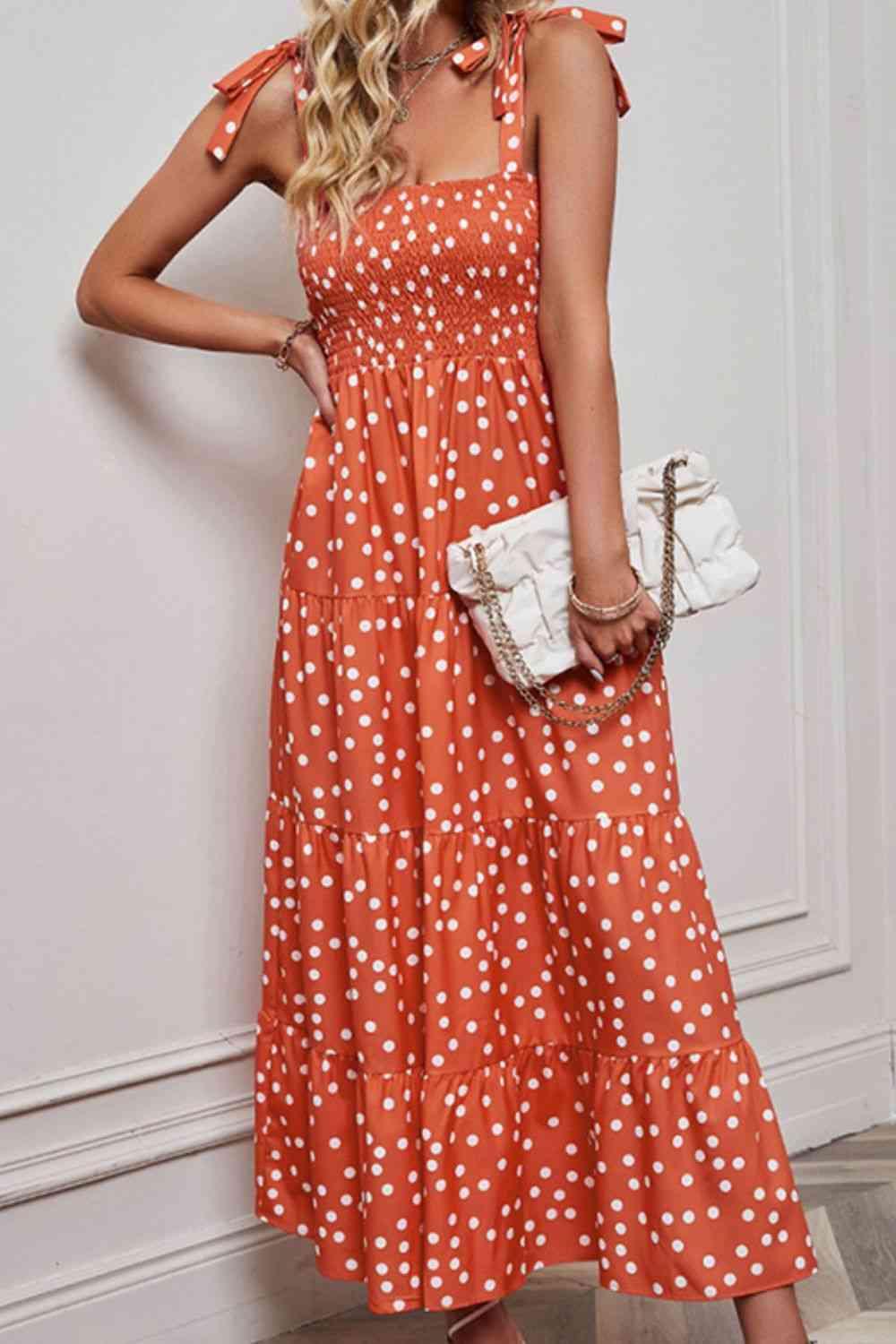 a woman in an orange polka dot dress