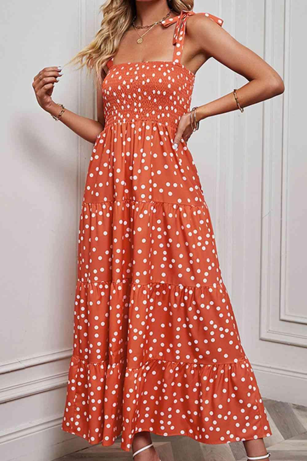 a woman in an orange polka dot print dress
