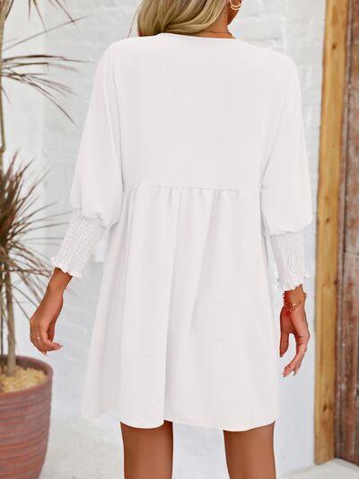 a woman wearing a white shirt dress