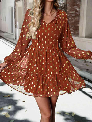 a woman wearing a brown polka dot dress