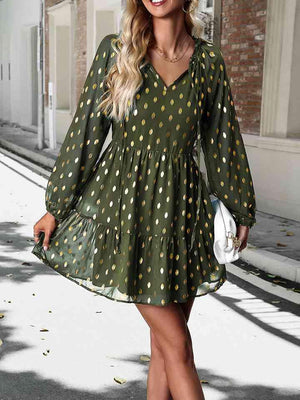 a woman wearing a green polka dot dress