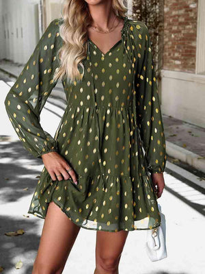 a woman wearing a green polka dot dress