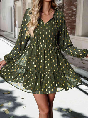 a woman wearing a green polka dot dress