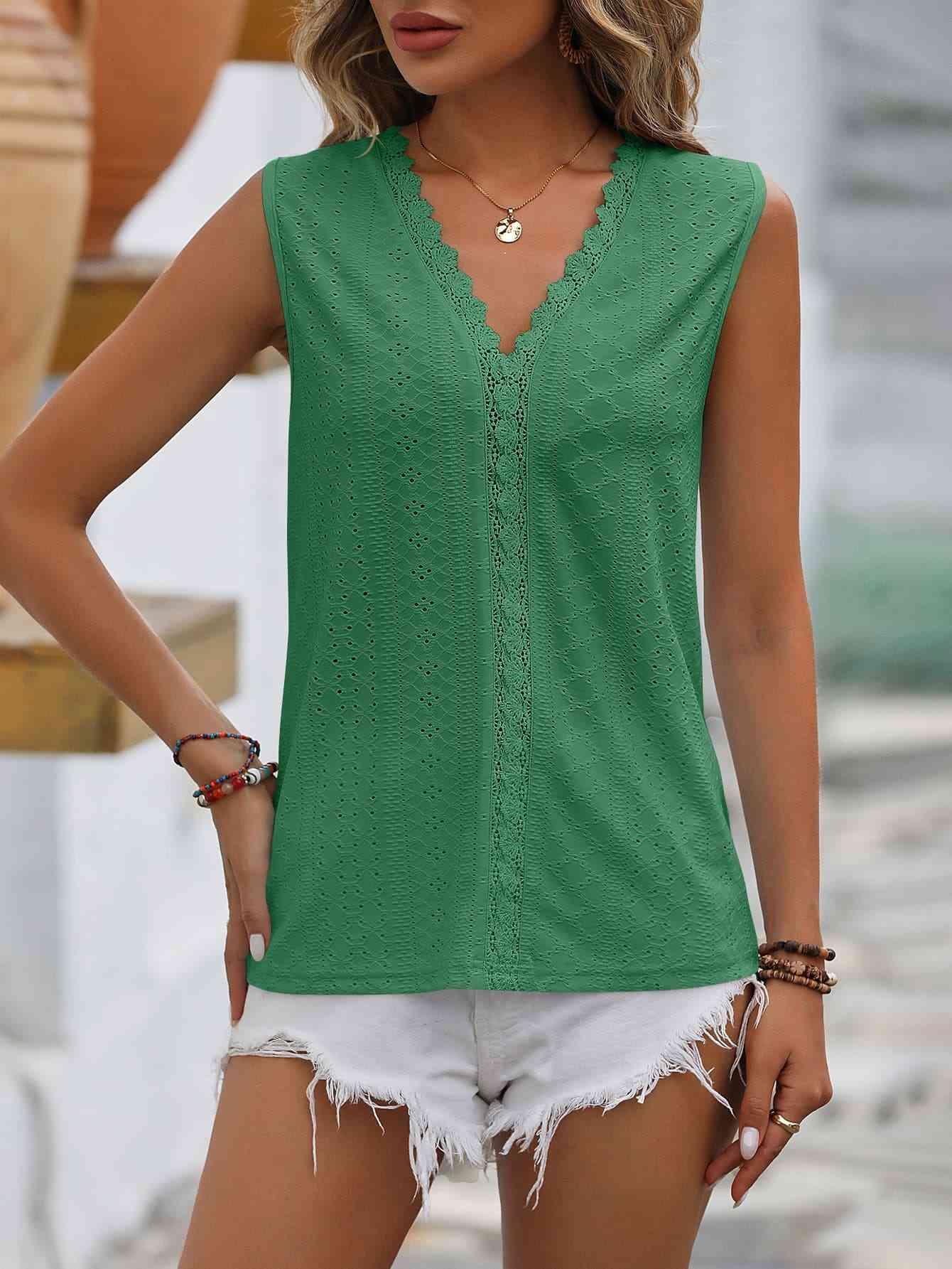 a woman wearing a green top and white shorts