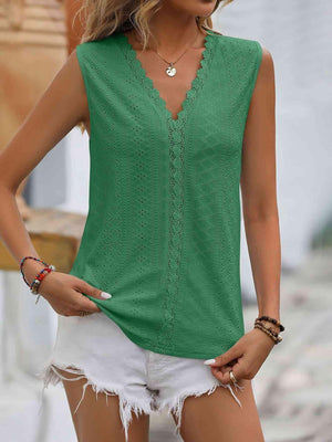 a woman wearing a green top and white shorts